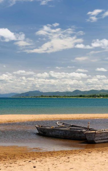 19968515 - tanzania, tanganyika lake  is the worlds longest and second deepest fresh water lake, it is also one of the oldest lakes on the planet  the picture presents beautiful sand beach and traditional boats